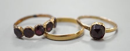 Two 19th century yellow metal and garnet set rings, including five stone half hoop, size J and