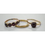 Two 19th century yellow metal and garnet set rings, including five stone half hoop, size J and