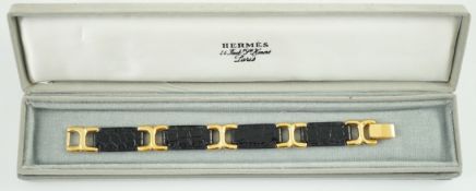 A boxed Hermes navy blue leather and gilt metal bracelet, 19cm.