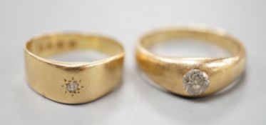 Two 18ct gold and gypsy set solitaire diamond rings, largest size T/U, gross weight 11.3 grams.