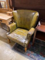 A green leather library armchair, width 73cm, depth 78cm, height 89cm