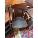 An early 20th century beech swivel desk chair, width 56cm, depth 48cm, height 92cm