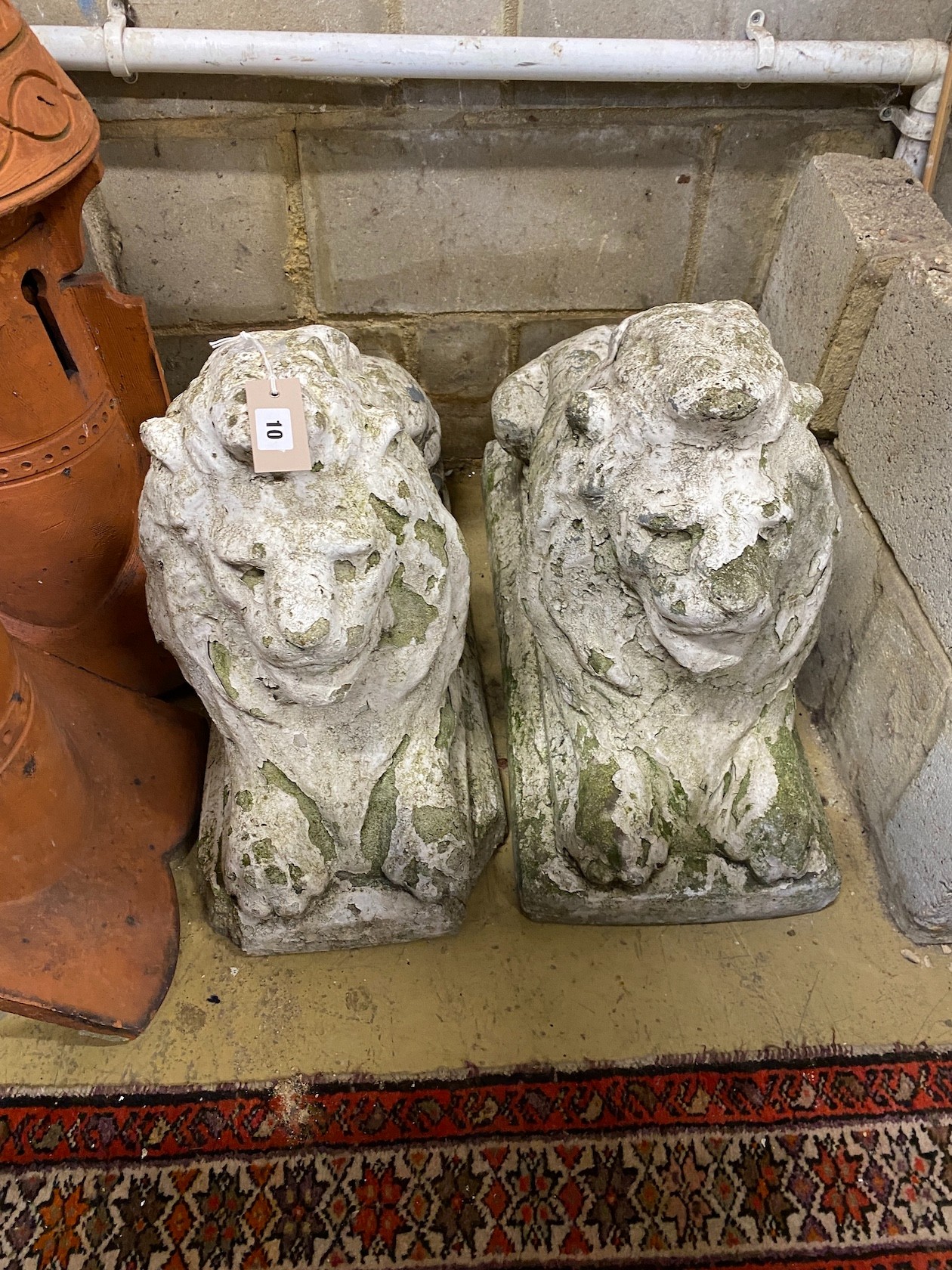 A pair of reconstituted stone recumbent lion garden ornaments, length 70cm, height 50cm - Image 2 of 2