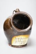 A glazed stoneware salt dispenser, inscribed in slip Mrs Barbour 9th Decr. 1879, 25cm