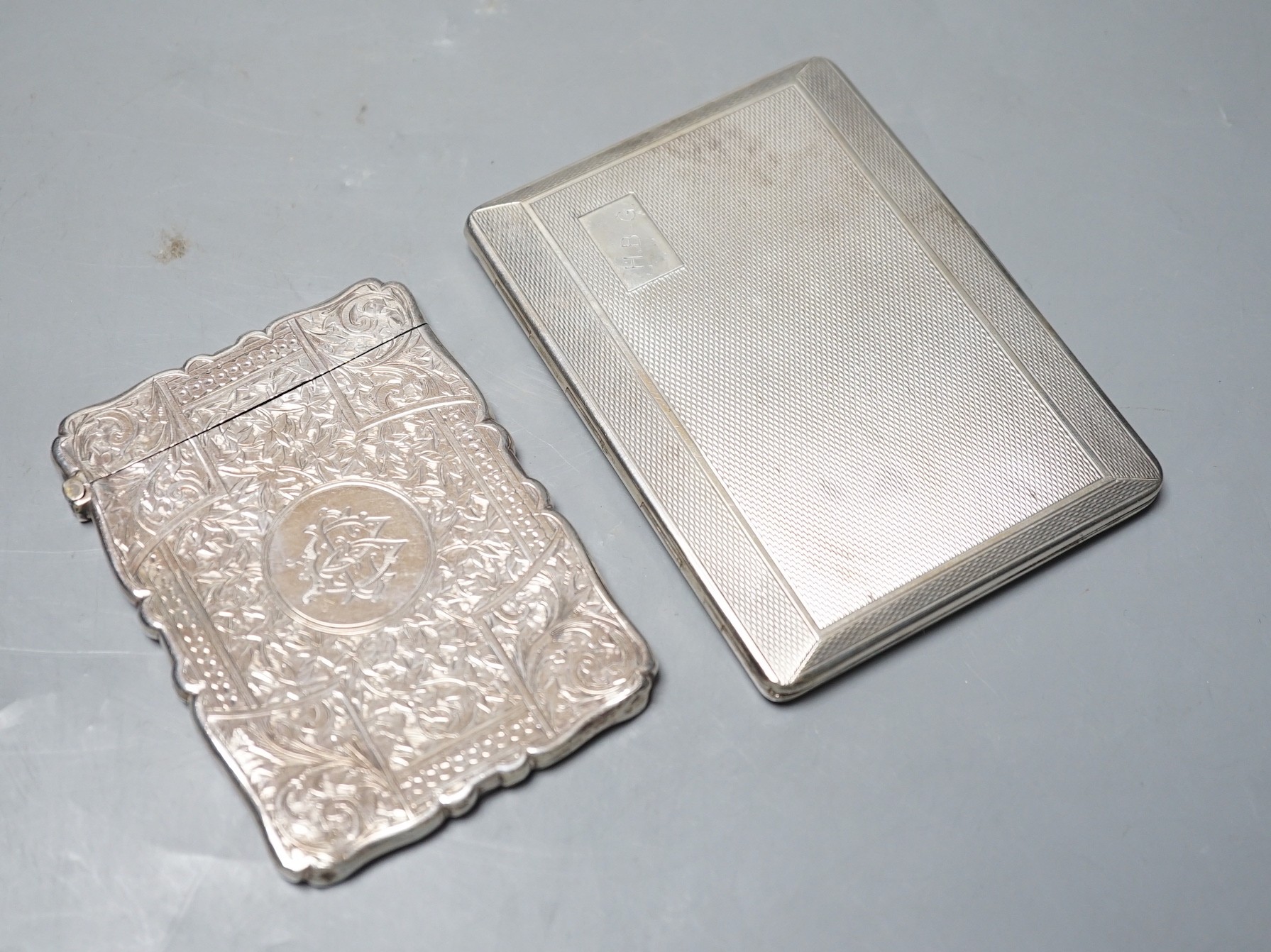 A late Victorian engraved silver calling card case, Birmingham, 1892, 98mm, and a George V engine