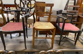 A pair of late Victorian style corner elbow chairs and a rush seat chair
