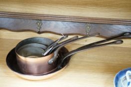 † † Two copper frying pans by Yves Gautier in Villedieu and three saucepans with an oak 5 hook pan