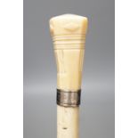 A whale bone walking stick with a whale tooth carved handle, with silver mount, 19th century