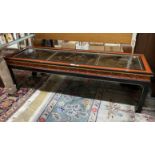 A Chinese black and red lacquered coffee table, the top inset three 18th century lacquer panels,