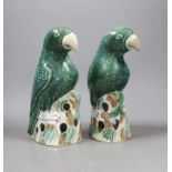 A pair of Asprey marked ceramic parrots on perches made for Recollections Ltd. by Gladstone