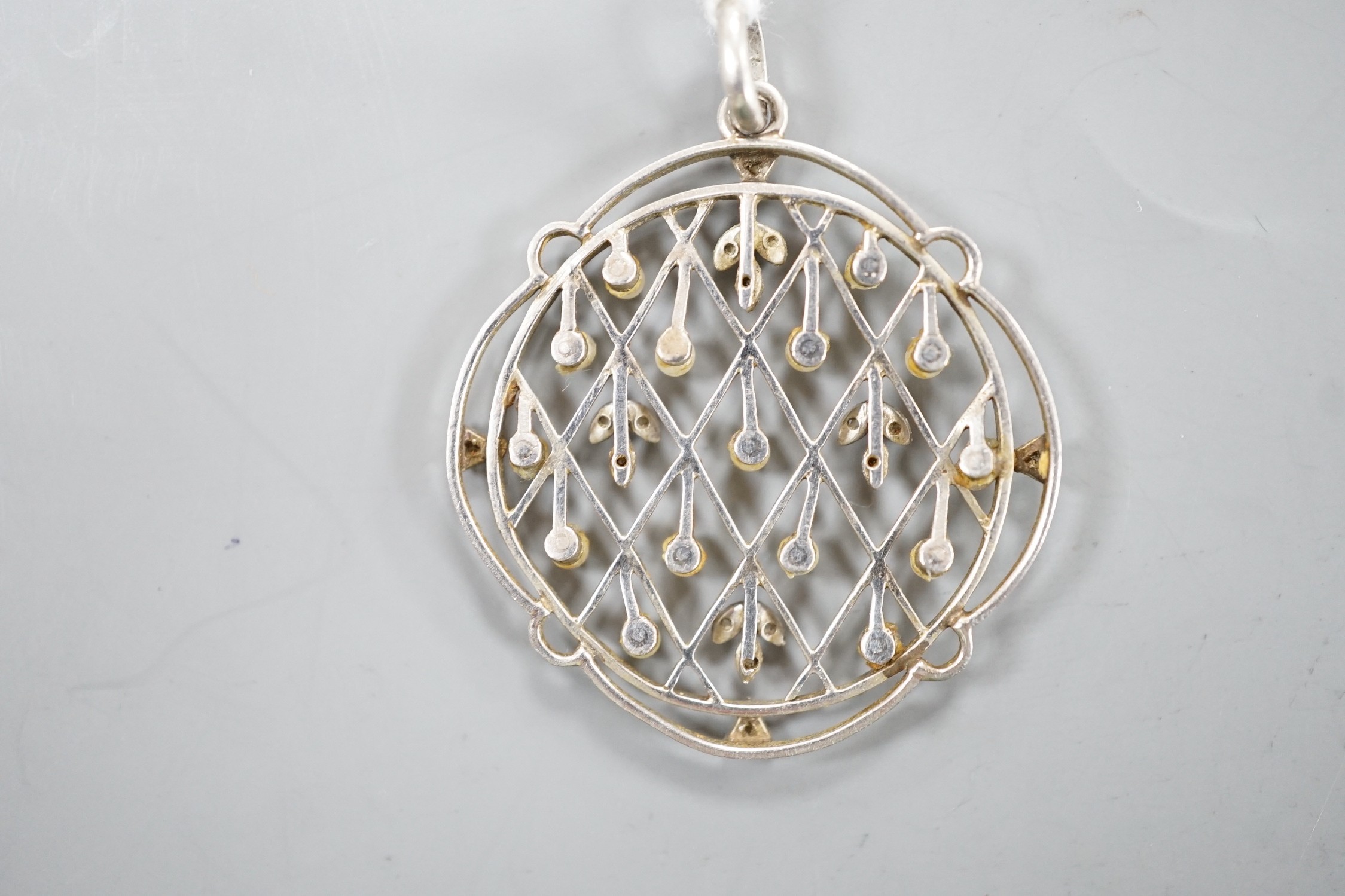 An early 20th century white metal, rose cut diamond chip and seed pearl set openwork pendant, - Image 2 of 2