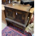 A 1920's Jacobean Revival carved oak cabinet on stand, width 91cm, depth 49cm, height 100cm