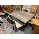 A contemporary industrial style rectangular bleached wood dining table on cast metal base, length