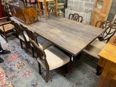 A contemporary industrial style rectangular bleached wood dining table on cast metal base, length