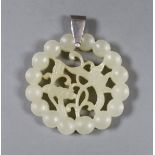 A Chinese carved circular jade pendant. 5.5cm diameter