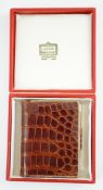 A boxed Cartier, London simulated crocodile notebook with silver pencil, unused, 8 cm.