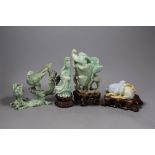 Four Chinese jadeite carvings, three on hardwood stands. Including a pig and piglets, two birds on a