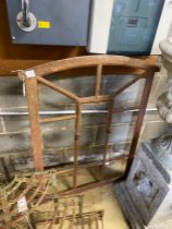 A cast iron arched topped window frame, width 88cm, height 112cm
