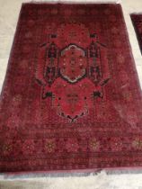 An Afghan red ground rug, 200 x 130cm