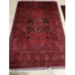 An Afghan red ground rug, 200 x 130cm