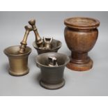 Three bell metal mortars, two pestles, a turned lignum vitae mortar and three postal weights, urn