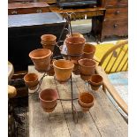 Fifteen small terracotta pots on wrought iron stand, height 52cm
