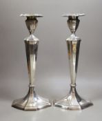 A pair of North American sterling candlesticks, with panelled stems and shaped oval bases, 34.1cm,