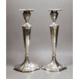 A pair of North American sterling candlesticks, with panelled stems and shaped oval bases, 34.1cm,