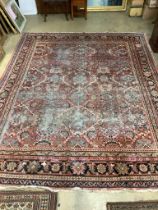 An early 20th century Heriz brick red ground carpet (worn), 418 x 330cm