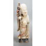 An 18th century Chinese carved soapstone figure of Shao Lou on carved hardwood stand. 24cm high (a.