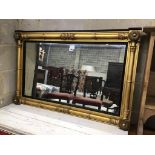 A William IV giltwood and composition overmantel mirror with ebonized slip width 106cms, height