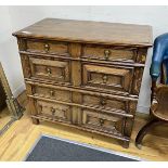 A late 17th century oak two part chest of two short and three long drawers, with geometric moulded