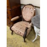 A Victorian carved walnut spoon back open armchair, width 71cm, depth 60cm, height 95cm