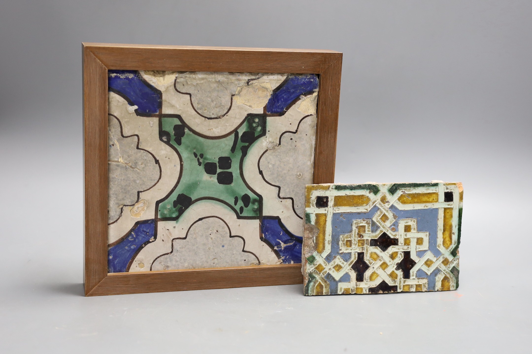 A Spanish tin-glazed earthenware floor tile, 16th/17th century and a larger tile, possibly