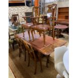 A Queen Anne revival figured walnut extending dining table, length 183cm extended, one spare leaf,