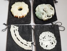 Three Chinese jade celadon roundels/pendants and a huang plaque, carved dragon roundel 5.5 cms