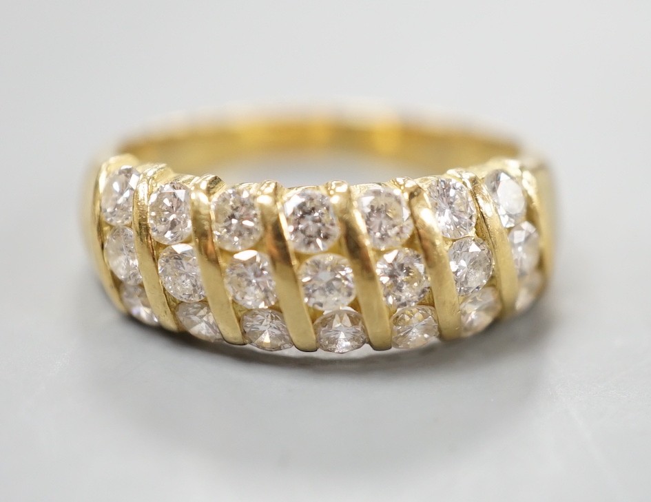 A modern 18ct gold and twenty one stone diamond set seven row half hoop ring, size N, gross weight