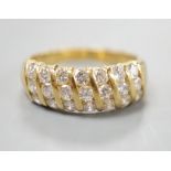 A modern 18ct gold and twenty one stone diamond set seven row half hoop ring, size N, gross weight