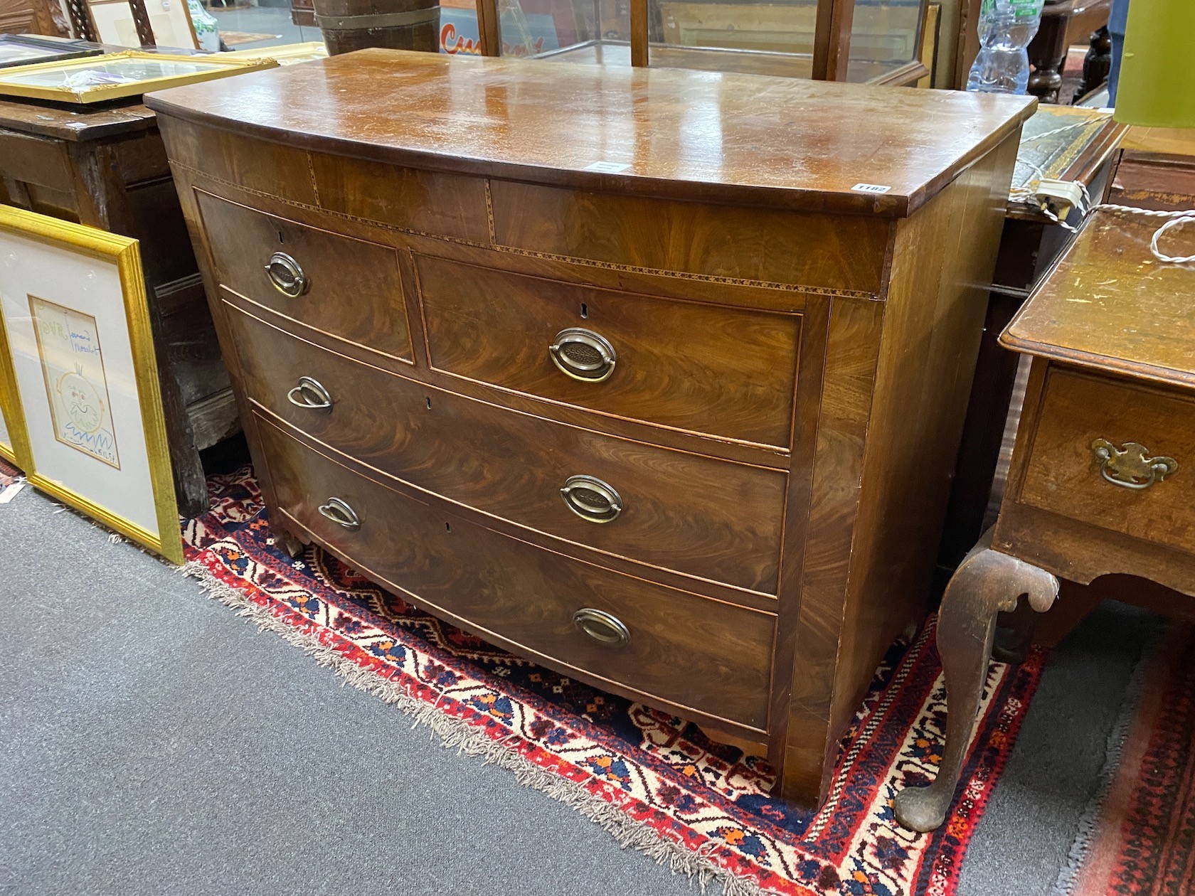 A George IV mahogany bow front chest, of two short and two long drawers incorporating a secret