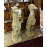 A pair of reconstituted stone seated greyhound garden ornaments, height 74cm