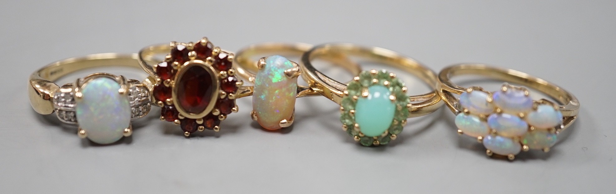 Five assorted modern 9ct gold and gem set dress rings, including white opal and diamond chip