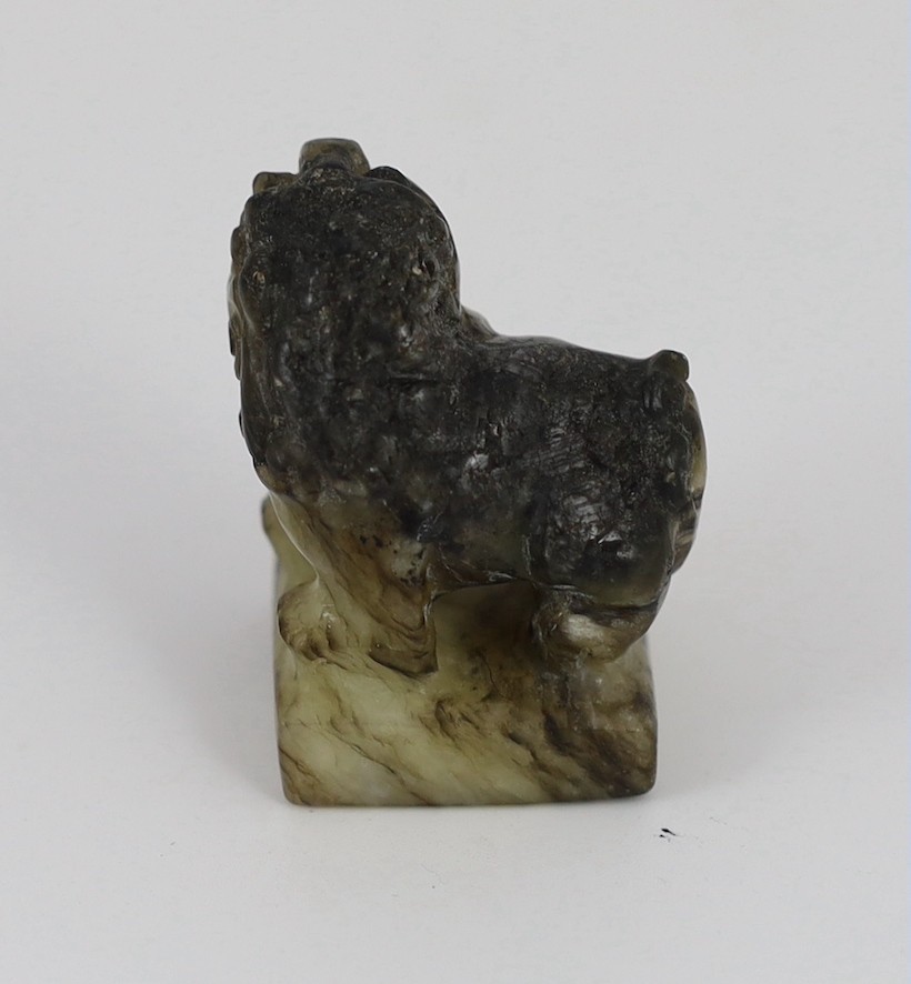 A Chinese pale celadon and black jade ‘lion-dog’ seal, 18th/19th century, the creamy white stone - Image 4 of 5