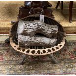 A Victorian cast iron fire grate, width 44cms and a plaster faux log stack.