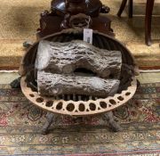 A Victorian cast iron fire grate, width 44cms and a plaster faux log stack.