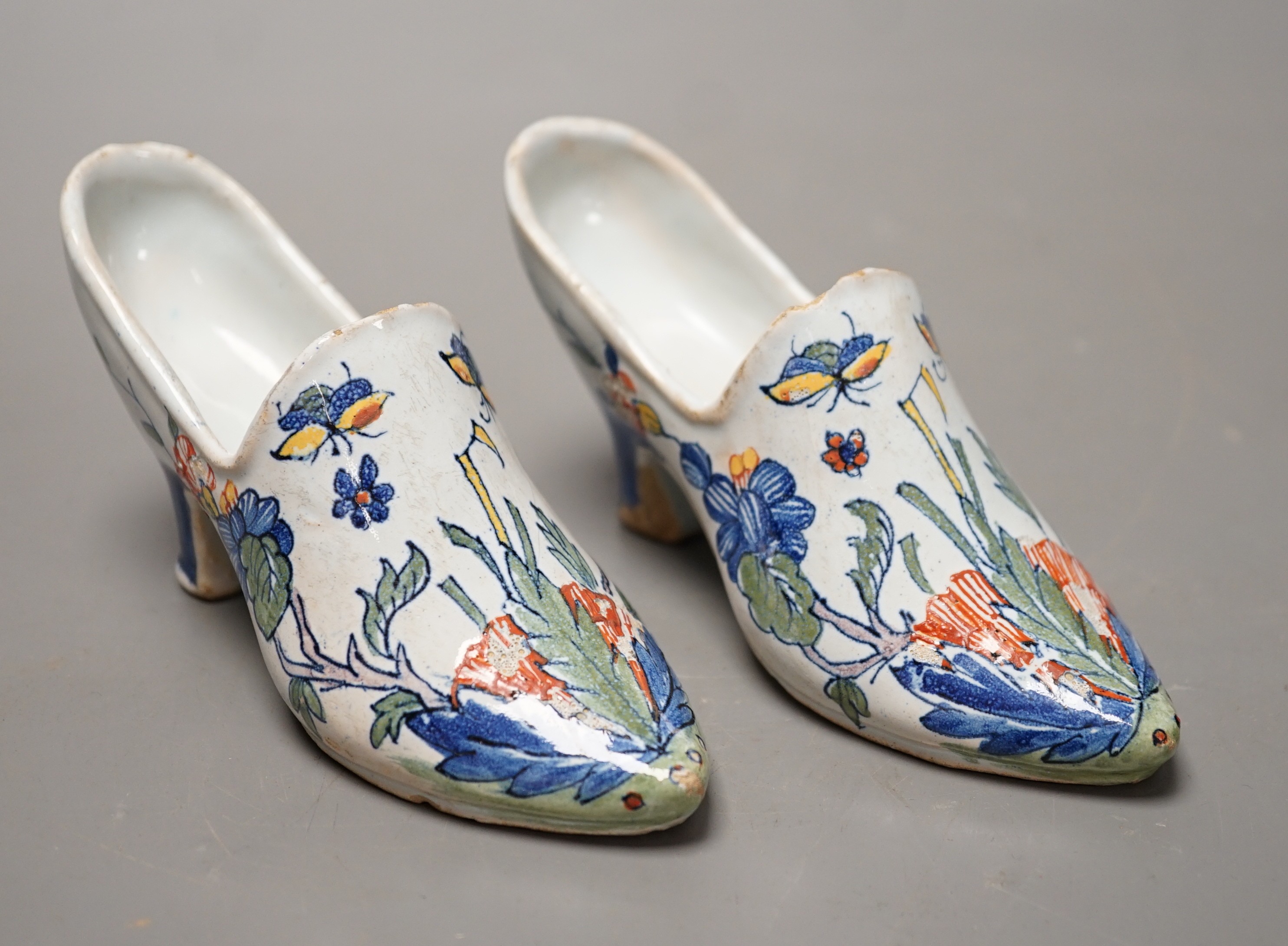 A pair of 19th century Delft polychrome models of shoes, 14cms wide