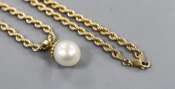 A modern 750 mounted cultured pearl pendant, overall 25mm, on a 375 ropetwist chain, 60cm, gross