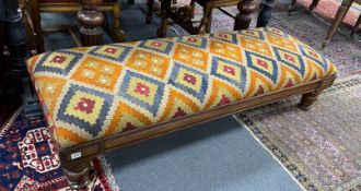 A William IV mahogany stool with polychrome kilim upholstered seat width 164cms, depth 59cms, height