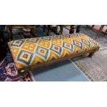 A William IV mahogany stool with polychrome kilim upholstered seat width 164cms, depth 59cms, height