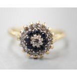 A 1960's 18ct gold, 18ct gold, sapphire and diamond set circular cluster ring, size O, gross