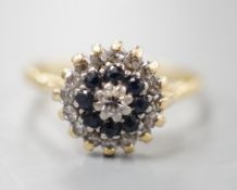 A 1960's 18ct gold, 18ct gold, sapphire and diamond set circular cluster ring, size O, gross